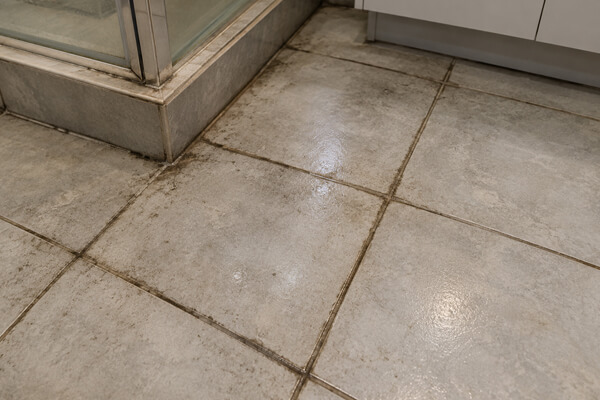 Tiled floor and grout lines before professional cleaning in Rugby